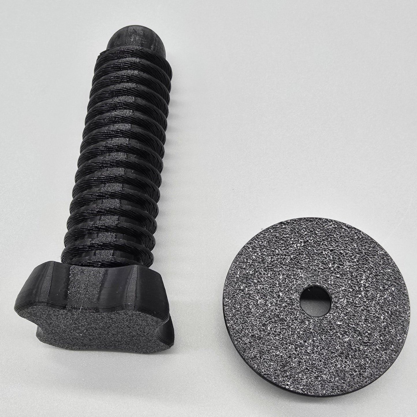 Black screw and Pad on a light gray background