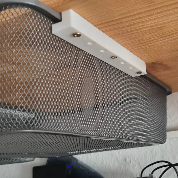 Mesh screen on a wooden surface with tools in the background