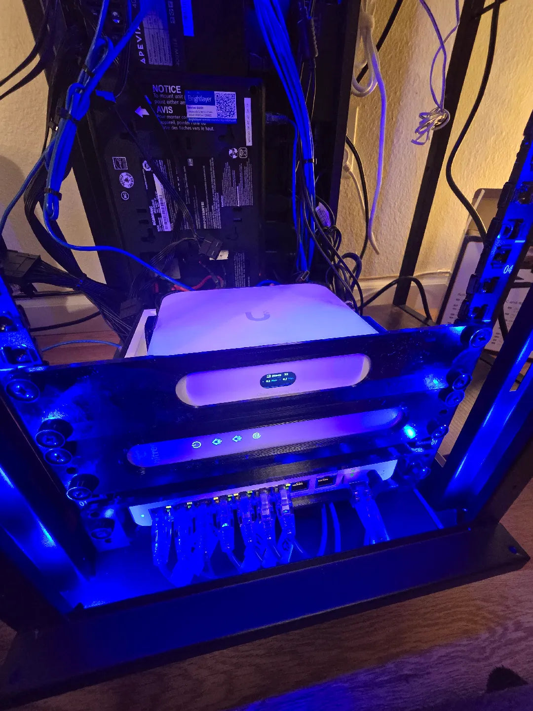 Computer case with blue LED lighting on a wooden surface