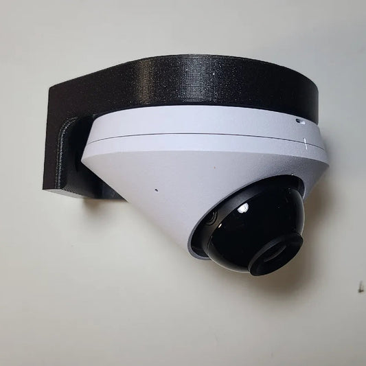White security camera with black bracket on a light gray wall