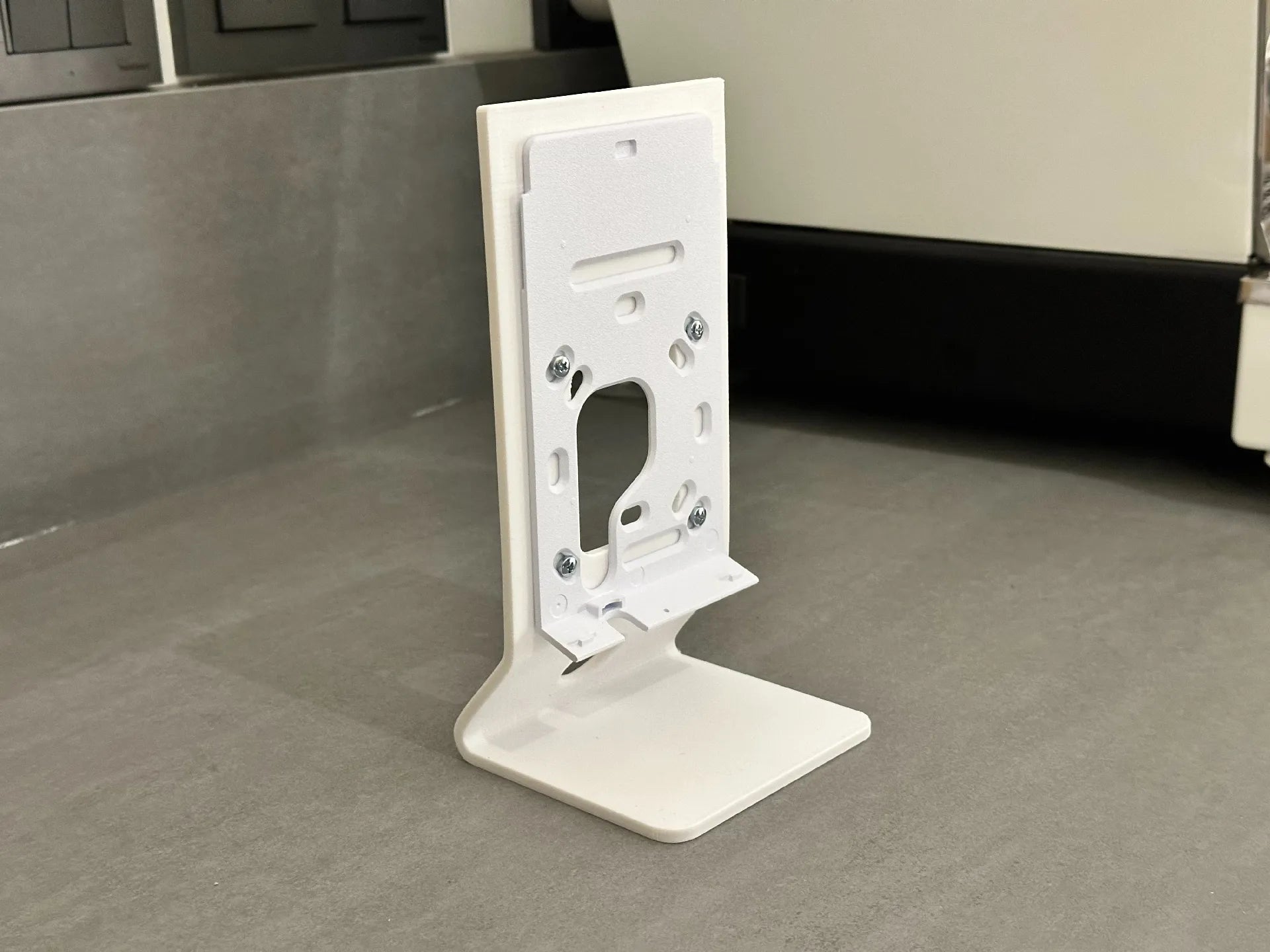 Close-up rear view of the UniFi U7 Pro Wall desk mount showing secure M3 bolt attachment points to the metal plate
