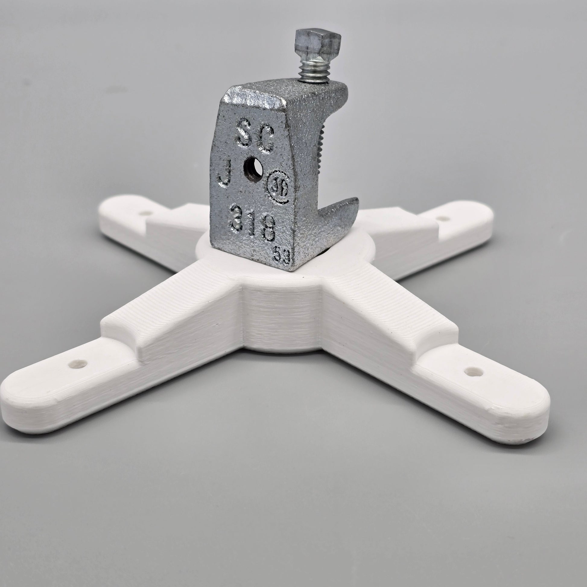 White plastic clamp with metal clamp on a gray background