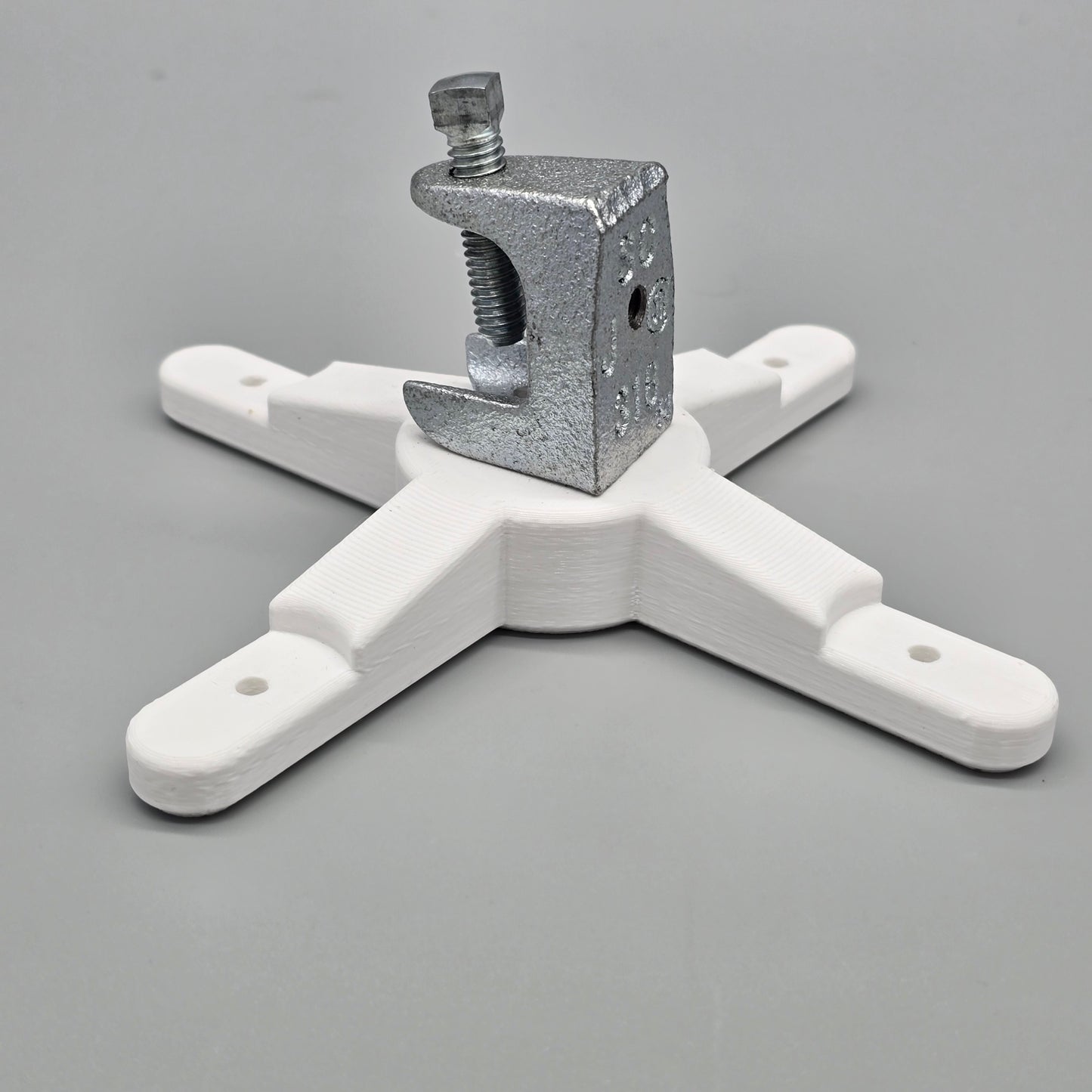 White metal bracket with a clamp on a gray background