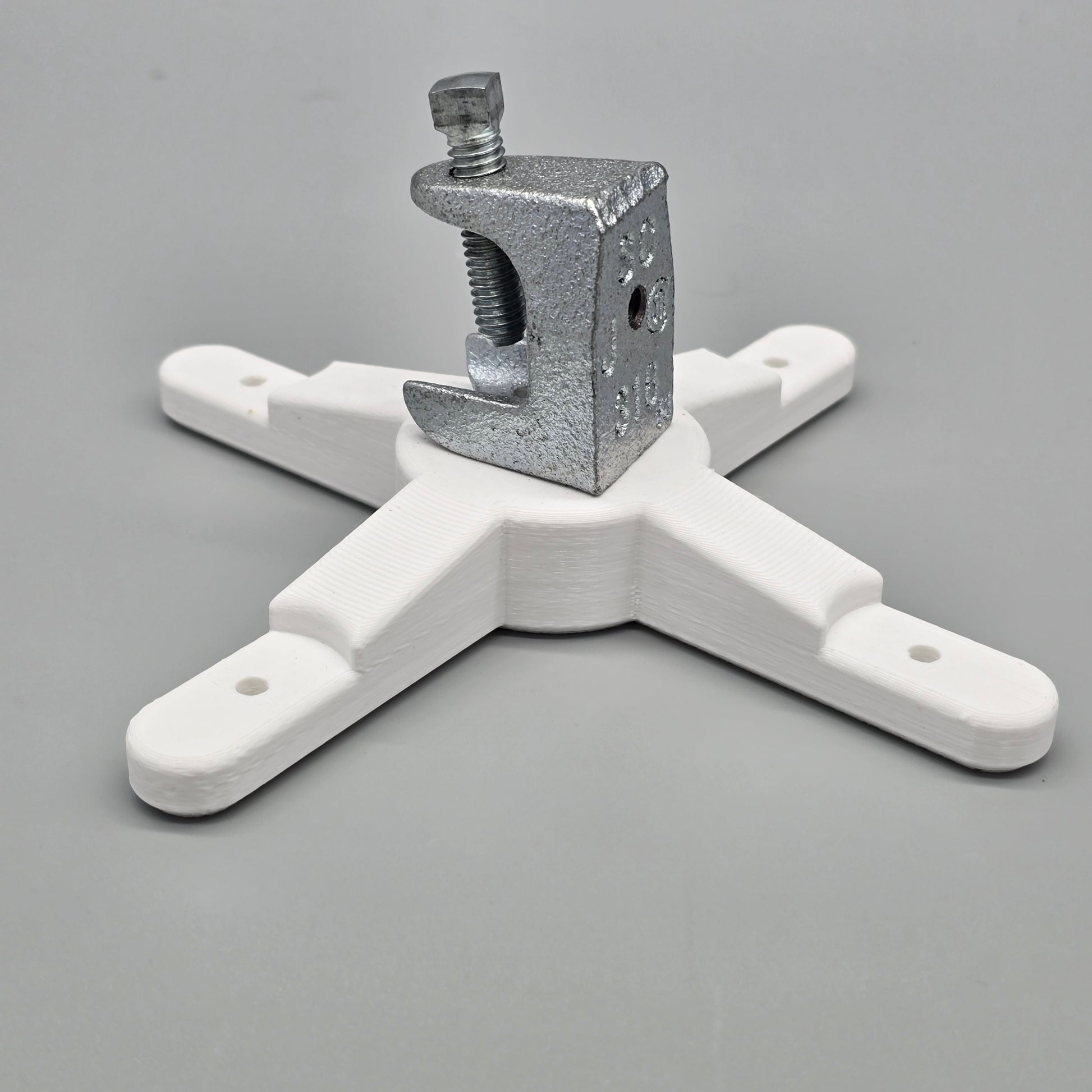White metal bracket with a clamp on a gray background